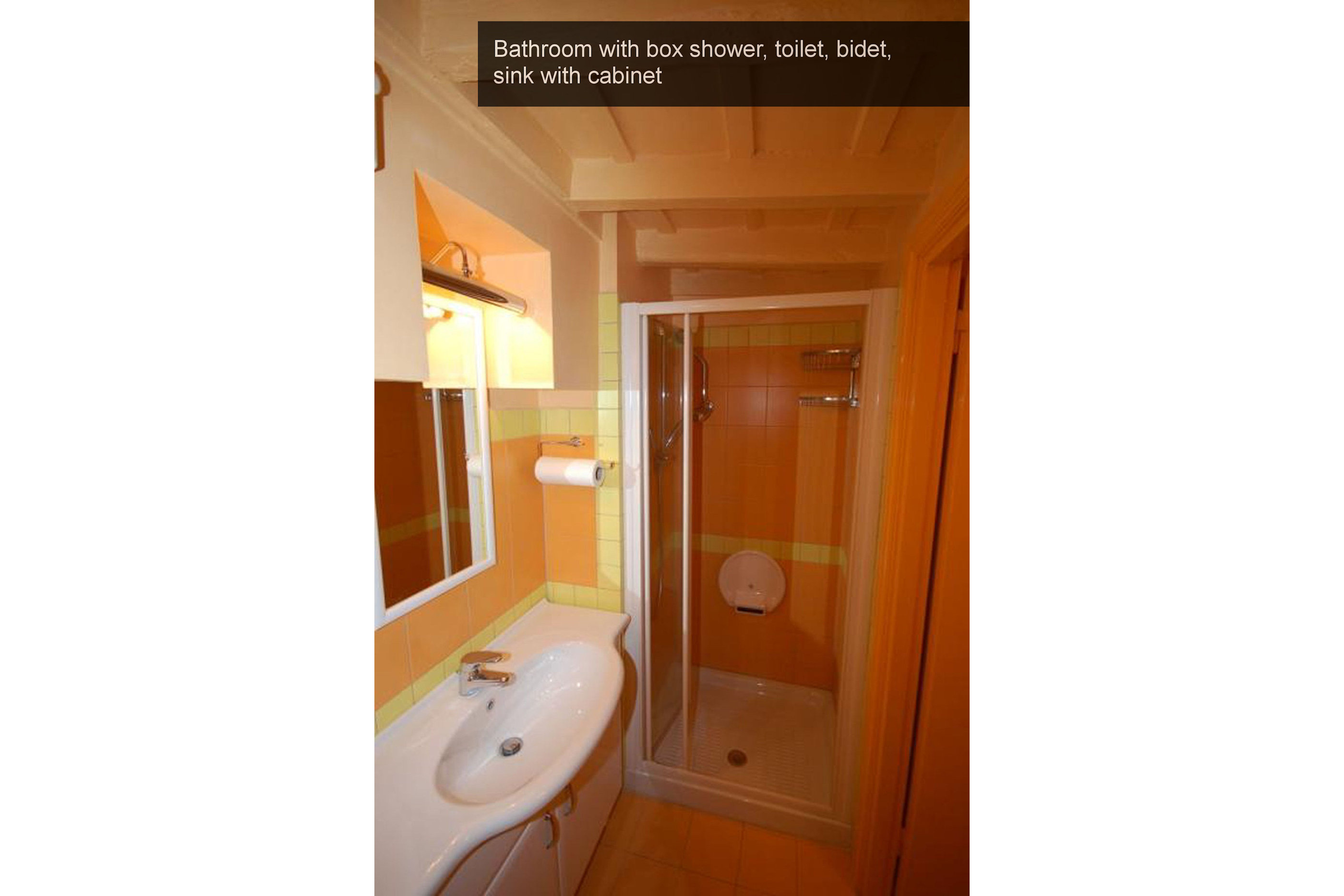 11) bathroom with box shower, toilet, bidet, sink with cabinet